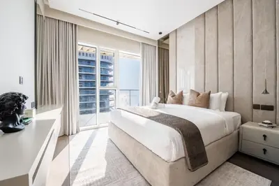 a bedroom with a large bed and a large window at Luxurious Bliss - 3-BR plus maids - Grand Bleu by Elie Saab in Dubai