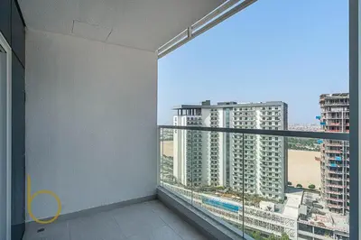 a room with a balcony with a view of a city at Bookable 1 Bed in Opalz by Danube in Dubai