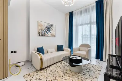 a living room with a couch and a chair and a table at Bookable 1 Bed in Opalz by Danube in Dubai
