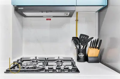 a stove top in a kitchen with utensils at Bookable 1 Bed in Opalz by Danube in Dubai