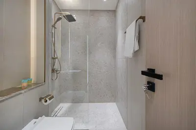 a bathroom with a shower with a toilet and a sink at Stylish Family Retreat That Sleeps 6 In The Heart of JVC in Dubai