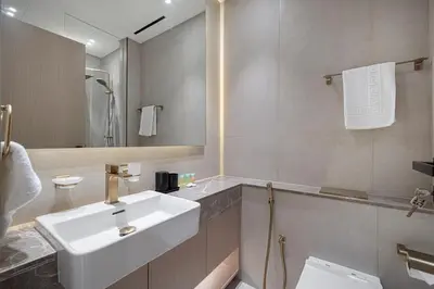 a bathroom with a white sink and a mirror at Stylish Family Retreat That Sleeps 6 In The Heart of JVC in Dubai