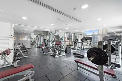 a gym with treadmills and machines in a building at Cozy Apartment in Central Dubai Marina near Beach in Dubai