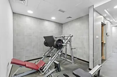 a gym with a red treadmill in a room at Cozy Apartment in Central Dubai Marina near Beach in Dubai