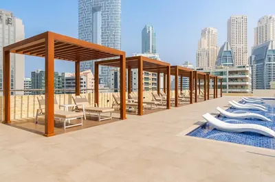a pavilion on the roof of a building with chairs at Cozy Apartment in Central Dubai Marina near Beach in Dubai