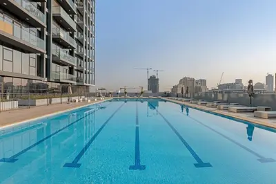 a large swimming pool on top of a building at Lush 1BR Apt at Bloom tower in JVC in Dubai