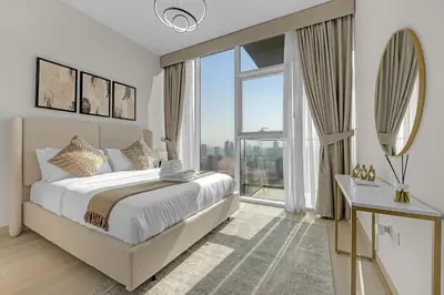a bedroom with a large bed and a large window at Lush 1BR Apt at Bloom tower in JVC in Dubai