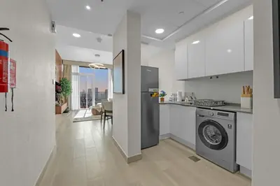 a kitchen with a washer and dryer in a room at Lush 1BR Apt at Bloom tower in JVC in Dubai