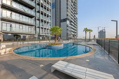 a swimming pool in the middle of a building at Lush 1BR Apt at Bloom tower in JVC in Dubai