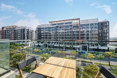a view of a large building with a wooden table at Daniels Studio at Meydan with Community View in Dubai