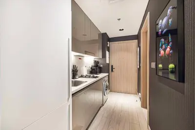 a kitchen with a sink and a stove top oven at Daniels Studio at Meydan with Community View in Dubai