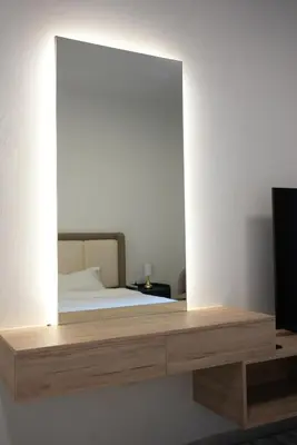 a mirror on a shelf in a bedroom with a bed at Marjan Escape Studio in Dubai