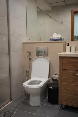 a bathroom with a white toilet and a sink at Marjan Escape Studio in Dubai