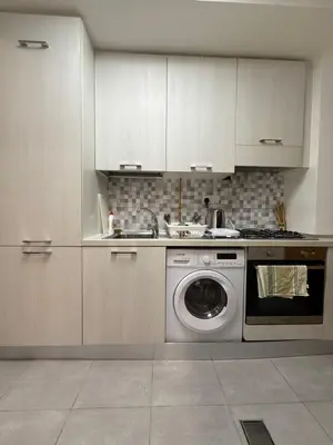 a kitchen with a sink and a washing machine at Marjan Escape Studio in Dubai