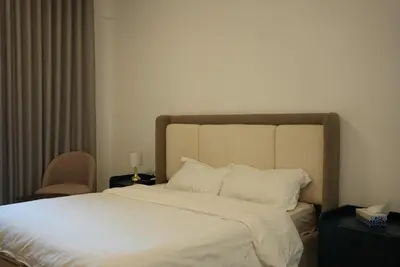a bedroom with a large bed with white sheets and pillows at Marjan Escape Studio in Dubai