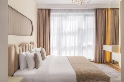 a bedroom with a white bed with a large window at Fountain & Opera Views 1 Bedroom Apartment with Balcony in Dubai