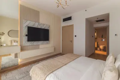 a bedroom with a bed and a flat screen tv at Fountain & Opera Views 1 Bedroom Apartment with Balcony in Dubai