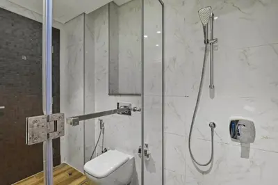 a bathroom with a shower with a toilet at Relax in Comfort with Modern Amenities, Steps from Burj Khalifa and Dubai Mall in Dubai