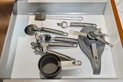 a drawer filled with different tools in a box at Relax in Comfort with Modern Amenities, Steps from Burj Khalifa and Dubai Mall in Dubai