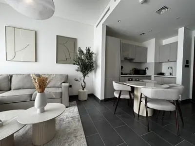 a living room with a couch and a table at Luxury 1-Bedroom Apartment with Pool Access in DIFC, Dubai in Dubai