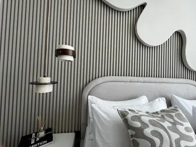 a bedroom with a bed and a striped wall at Luxury 1-Bedroom Apartment with Pool Access in DIFC, Dubai in Dubai