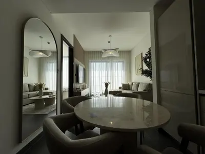 a living room with a table and chairs at Luxury 1-Bedroom Apartment with Pool Access in DIFC, Dubai in Dubai