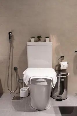 a bathroom with a toilet with a towel on it at Modern Studio with Balcony, Stunning City Views & Free Parking, Close to Dubai Mall in Dubai