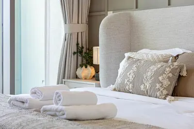 a bedroom with a bed with towels on it at Brand New 1BR, Downtown View, 5 Min Dubai Mall in Dubai