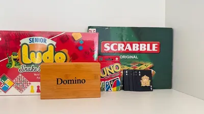a group of different types of snacks and books at Brand New 1BR, Downtown View, 5 Min Dubai Mall in Dubai