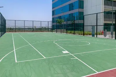 a tennis court in front of a building at Brand New 1BR, Downtown View, 5 Min Dubai Mall in Dubai