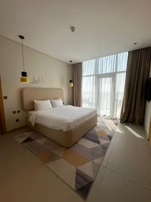 a bedroom with a bed and a large window at Novotel Residence in Dubai