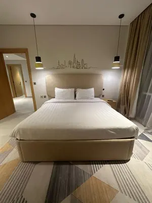 a bedroom with a large bed with white sheets at Novotel Residence in Dubai