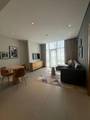 a living room with a couch and a table at Novotel Residence in Dubai