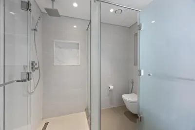 a bathroom with a shower and a toilet at 2BR at Opera Grand, Fountain and Burj Khalifa Views in Dubai