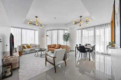 a living room with a couch and a table at 2BR at Opera Grand, Fountain and Burj Khalifa Views in Dubai