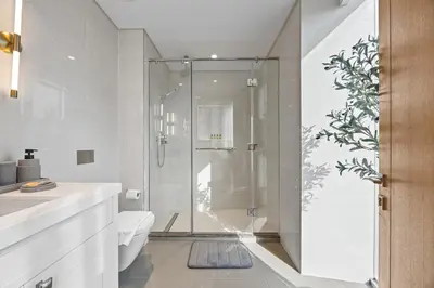 a bathroom with a shower and a toilet at 2BR at Opera Grand, Fountain and Burj Khalifa Views in Dubai