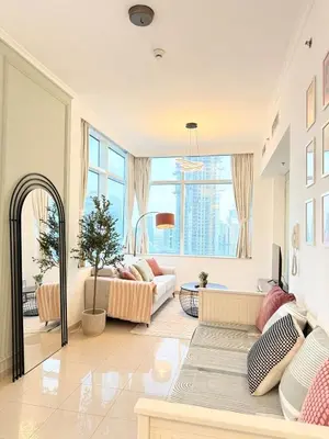 a living room with a couch and a large window at Peachy Mint - Luxury 1 BHK - Marina & Sea View in Dubai