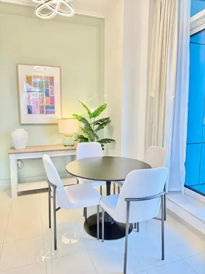 a dining room with a table and chairs at Peachy Mint - Luxury 1 BHK - Marina & Sea View in Dubai