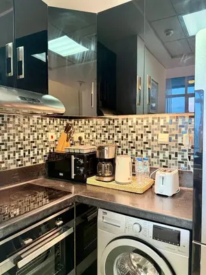 a kitchen with a washer and a washing machine at Peachy Mint - Luxury 1 BHK - Marina & Sea View in Dubai