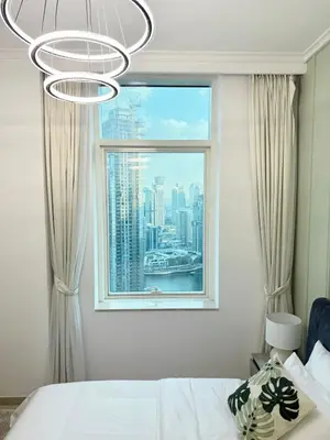 a bedroom with a window with a view of a city at Peachy Mint - Luxury 1 BHK - Marina & Sea View in Dubai