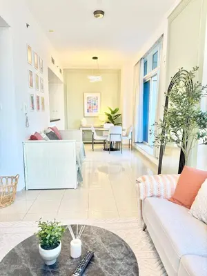 a living room with a couch and a table at Peachy Mint - Luxury 1 BHK - Marina & Sea View in Dubai