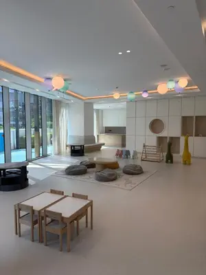a large living room with tables and a piano at Elegant High-Rise Escape with sea view by SoleaStay in Dubai