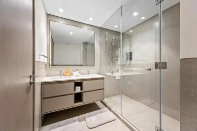 a bathroom with a sink and a shower at Elegant High-Rise Escape with sea view by SoleaStay in Dubai