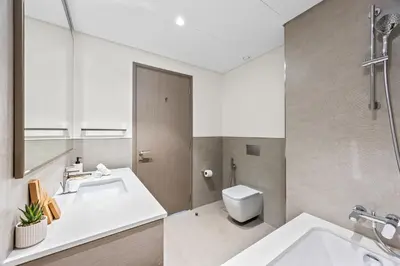 a bathroom with a sink and a toilet at Elegant High-Rise Escape with sea view by SoleaStay in Dubai