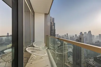 a balcony with chairs and a view of the city at Elegant High-Rise Escape with sea view by SoleaStay in Dubai