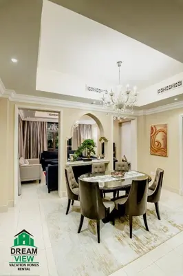 a dining room with a table and chairs at Souk Al Bahar View Burj Khalifa and Fountains Dream View Holiday Homes in Dubai