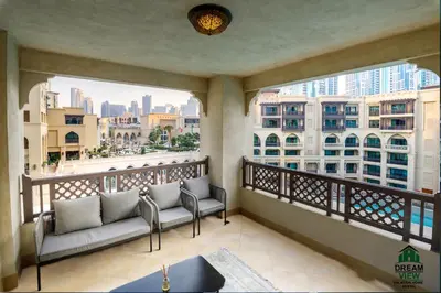 a balcony with couches and a view of the city at Souk Al Bahar View Burj Khalifa and Fountains Dream View Holiday Homes in Dubai