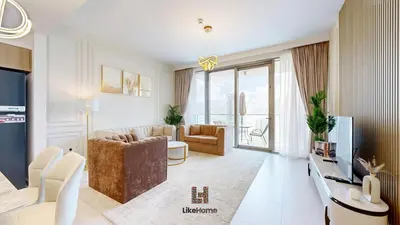 a living room with a couch and a television at Stylish2BR Apartment Iconic The Grand LH in Dubai