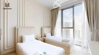 two beds in a room with a large window at Stylish2BR Apartment Iconic The Grand LH in Dubai