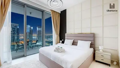 a bedroom with a bed and a view of a city at Stylish2BR Apartment Iconic The Grand LH in Dubai